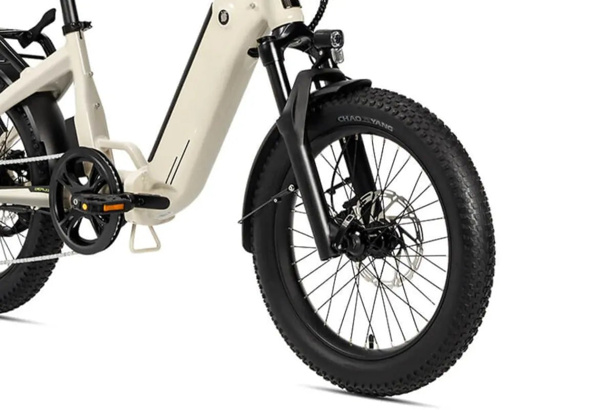 Front wheel of a warm grey Miniwave folding e-bike, close on the wide knobbly tyre