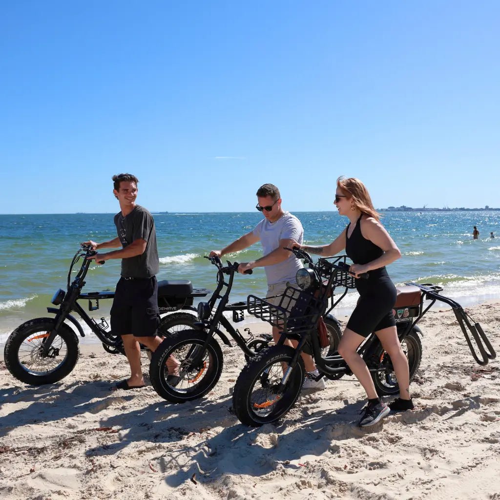 3 people wheeling RideWave Xplorer's at the beach